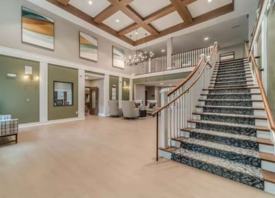 Spacious interior common area with staircase and seating.