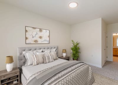 Cozy bedroom with modern decor and natural light.