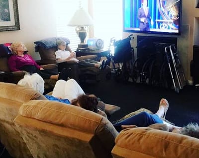 Residents watching television in a common area.