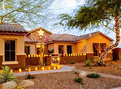 Exterior of a senior living facility decorated with lights.