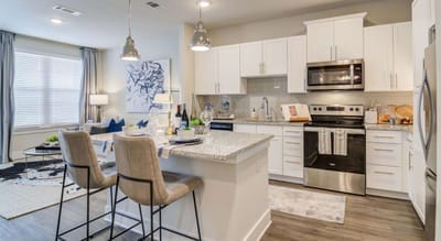 Modern kitchen with dining area in a residential setting.