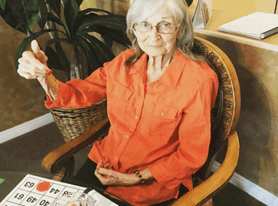 Resident playing bingo in a common area.