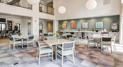 Bright dining area with modern decor and tables.