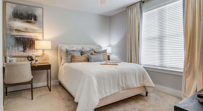 Cozy bedroom with modern decor and natural light.