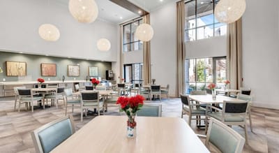 Bright dining area with flowers on tables.