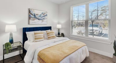 Cozy bedroom with a bed and window view.
