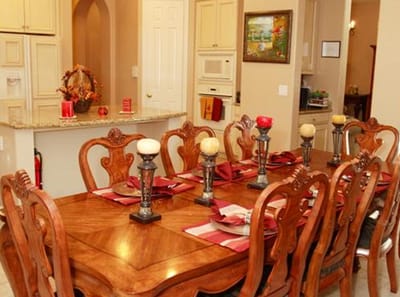 Elegant dining room with a large table set for a meal.