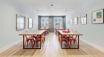 Modern dining room with wooden tables and chairs.