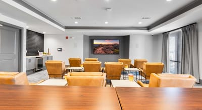 Cozy common area with seating and screen
