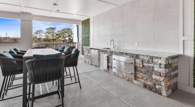 Outdoor kitchen space with seating area