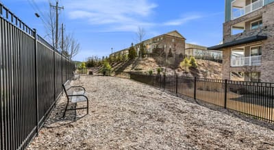 Outdoor walk area with benches and landscaping.