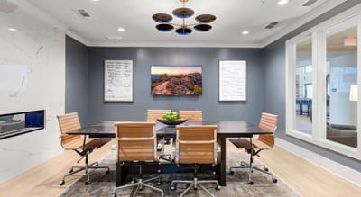 Modern conference room with seating and artwork.