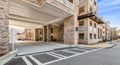 Building entrance with parking area visible