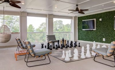 Outdoor chess area with seating and greenery