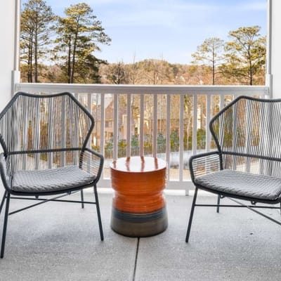 Outdoor seating area with two chairs and a table.