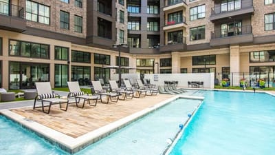 Outdoor pool area with lounge chairs.