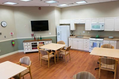 Interior common area with kitchenette and tables.