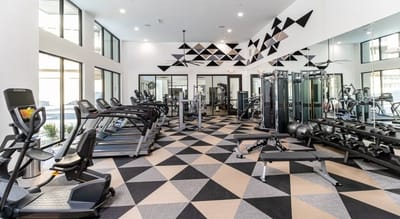 Well-equipped fitness room with exercise machines.