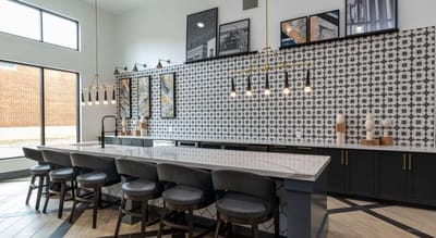 Modern interior space with seating and decorative wall.