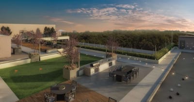 Outdoor patio area with seating and greenery