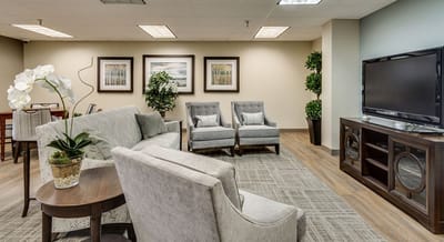 Modern lounge area with comfortable seating and plants.