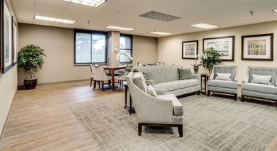 Bright common area with comfortable seating and artwork.