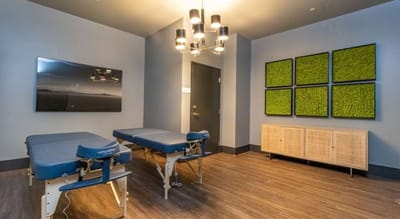 Therapy room with massage tables and decor
