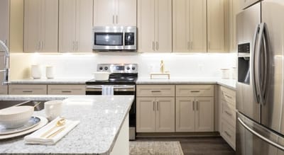 Modern kitchen with stainless steel appliances.