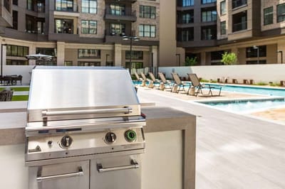 Outdoor grill near the swimming pool area.