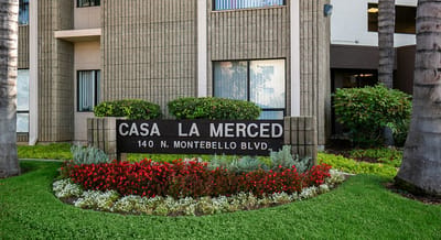 Exterior view of Casa La Merced facility with signage.