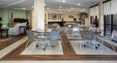 Common area with tables and chairs set up.