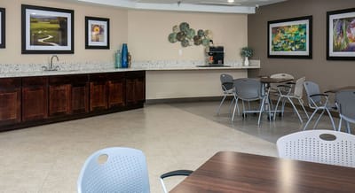 Bright common area with seating and decor.