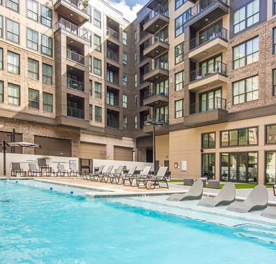 Outdoor pool area with seating and lounge chairs