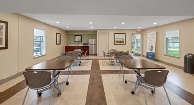Common area with tables and chairs in the facility