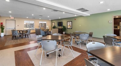 Bright common area with tables and chairs.