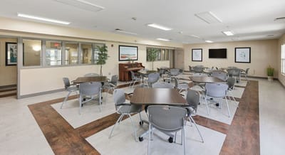 Spacious common area with tables and chairs
