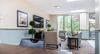 Bright common area with comfortable seating and plants.