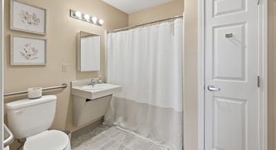 Neat bathroom with a shower, sink, and toilet