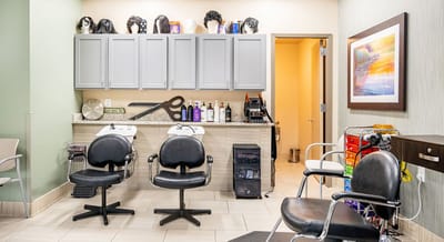 Interior of a salon with styling chairs and products.