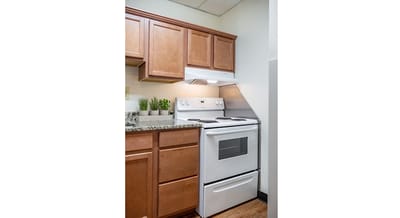 Kitchen area with cabinets and stove