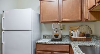 Kitchen area with appliances and granite counter
