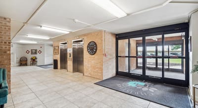Interior hallway with elevators and seating area