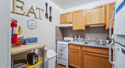 Cozy apartment kitchen with cooking supplies.