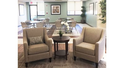 Cozy common area with chairs and dining space.