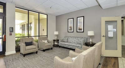Common area with comfortable seating and large windows