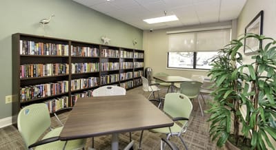 Interior common area with bookshelves and tables.