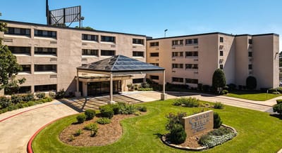 Exterior view of Cedar Hills facility with landscaped grounds.