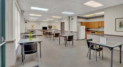 Bright common area with tables and chairs.