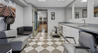 Hair salon area with chairs and mirrors