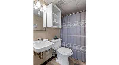 Clean, simple bathroom with shower curtain and sink.